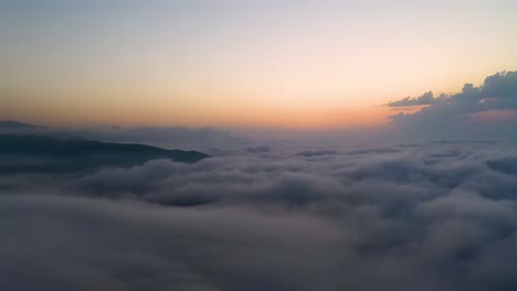 Flying-over-the-clouds-with-the-late-sun.-Sunrise-or-sunset-colorful-sky-background.