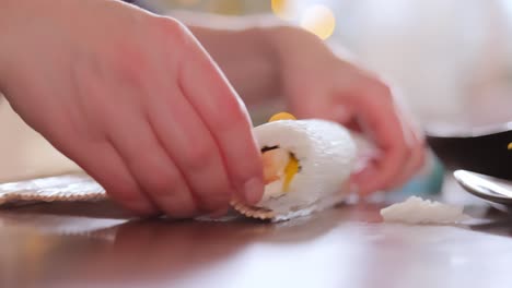 Making-Sushi-at-Home-Kitchen.-Woman-hands-rolling-homemade-sushi.