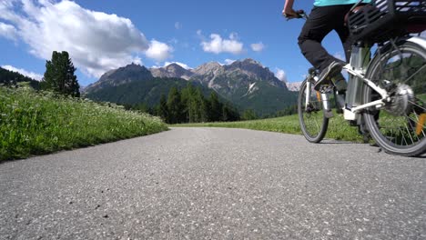 Man-on-electric-eco-bike-cycling-Italy-Dolomites-Alps