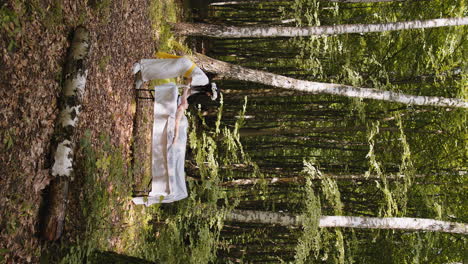 Therapist-female-doctor-making-woman-relaxing-spa-face-massage-with-hands-outdoors-in-the-forest