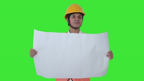 Happy-Indian-architect-looking-at-the-blueprint-of-building-Green-screen