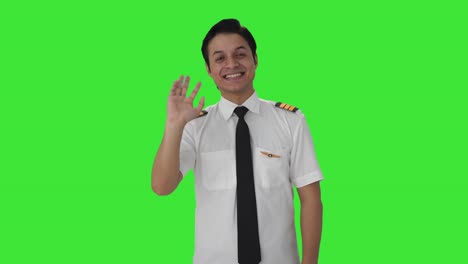 Happy-Indian-pilot-saying-hello-Green-screen
