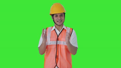 Happy-Indian-architect-talking-to-someone-Green-screen
