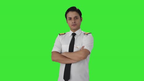 Porträt-Eines-Indischen-Männlichen-Piloten,-Der-Mit-Gekreuzten-Händen-Auf-Grünem-Bildschirm-Steht