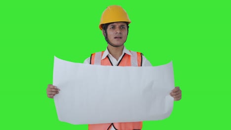 Confused-Indian-architect-looking-at-the-blueprint-of-building-Green-screen