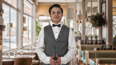 Happy-Indian-waiter-smiling-to-the-camera