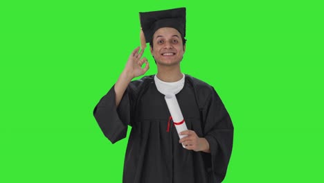 Happy-Indian-college-student-showing-okay-sign-Green-screen
