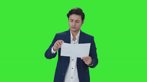 Indian-manager-checking-financial-reports-Green-screen