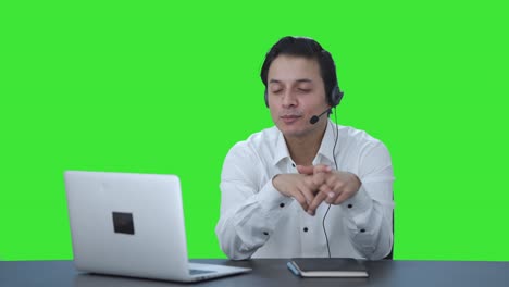 Happy-Indian-call-center-employee-talking-to-customer-Green-screen