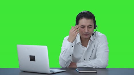 Stressed-Indian-call-center-employee-talking-to-customer-Green-screen