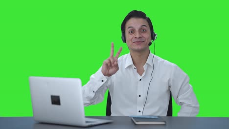Happy-Indian-call-center-employee-showing-victory-sign-Green-screen