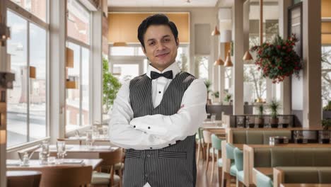 Portrait-of-Happy-Indian-waiter-standing-crossed-hands