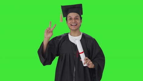 Happy-Indian-college-student-showing-victory-sign-Green-screen