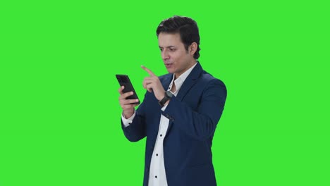 Happy-Indian-manager-using-mobile-phone-Green-screen