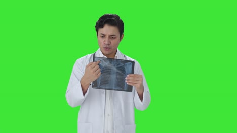 Happy-Indian-doctor-explaining-x-ray-report-to-patient-Green-screen