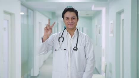 Happy-Indian-doctor-showing-victory-sign