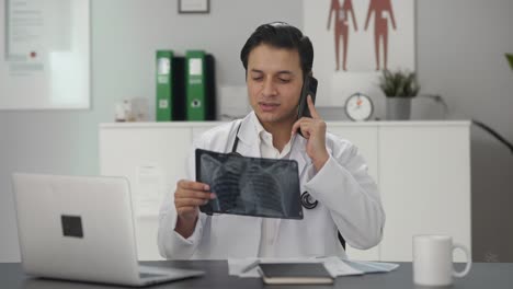Indian-doctor-explaining-X-ray-report-on-phone