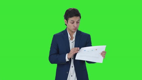Indian-manager-discussing-reports-in-meeting-Green-screen