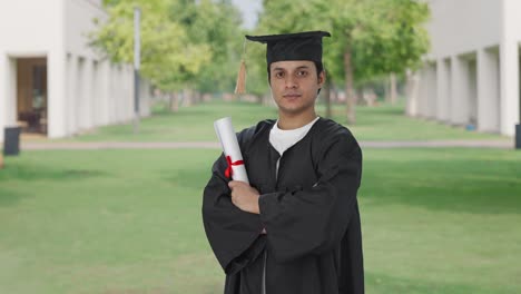 Portrait-of-Indian-graduate-student-standing-crossed-hands