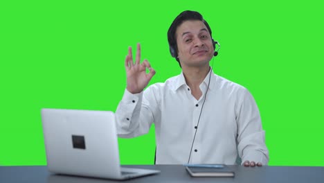 Happy-Indian-call-center-employee-showing-okay-sign-Green-screen