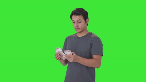 Confident-Indian-man-counting-money-Green-screen