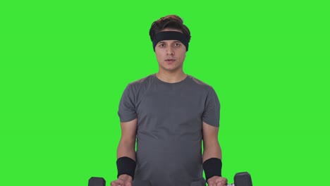 Indian-man-lifting-heavy-dumbells-and-doing-exercise-Green-screen