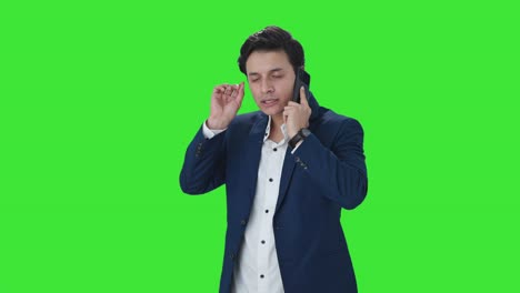 Indian-manager-talking-on-mobile-phone-Green-screen