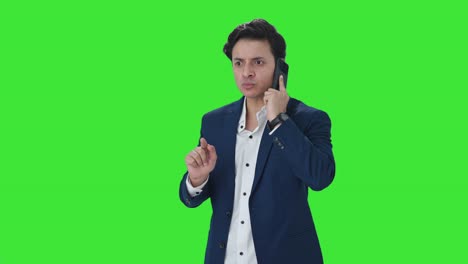Angry-Indian-manager-shouting-on-mobile-phone-Green-screen