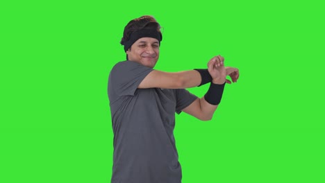 Happy-Indian-man-doing-arm-stretching-Green-screen