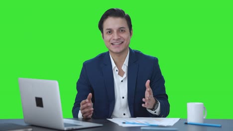 Happy-Indian-manager-talking-to-someone-Green-screen