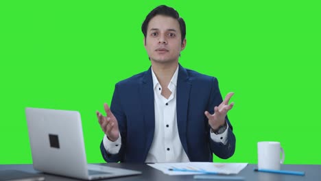 Indian-manager-talking-to-someone-Green-screen