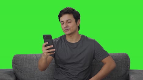 Happy-Indian-man-talking-on-video-call-Green-screen