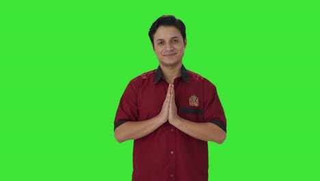 Happy-Indian-house-keeper-welcoming-guests-Green-screen