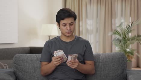 Indian-man-counting-money-at-home