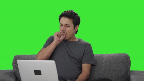 Tired-and-lazy-Indian-man-working-on-laptop-Green-screen
