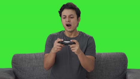 Tired-Indian-man-playing-video-games-Green-screen