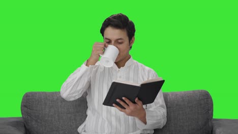 Happy-Indian-man-reading-a-book-Green-screen