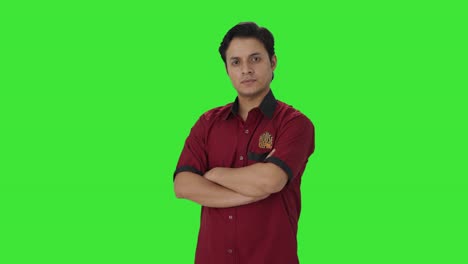 Portrait-of-confident-Indian-house-keeper-standing-crossed-hands-Green-screen