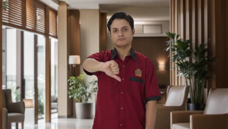 Disappointed-Indian-house-keeper-showing-thumbs-down