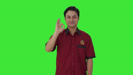 Happy-Indian-house-keeper-showing-okay-sign-Green-screen
