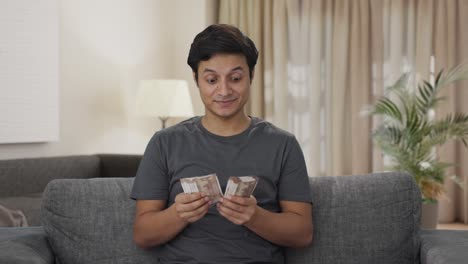 Happy-Indian-man-counting-money