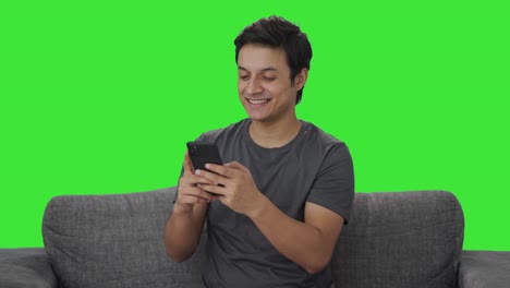 Happy-Indian-man-chatting-with-someone-Green-screen