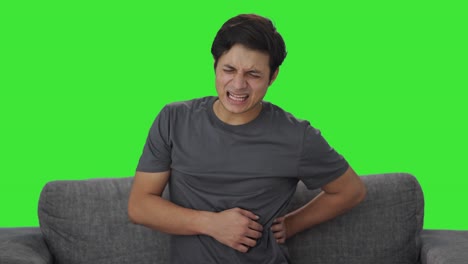 Sick-Indian-man-suffering-from-back-pain-Green-screen
