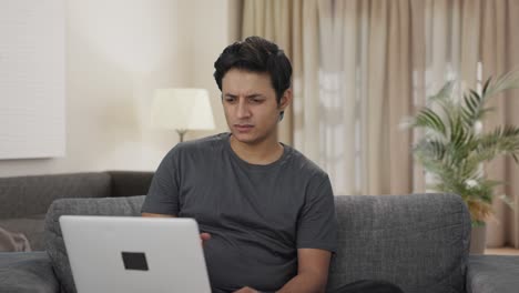 Confused-Indian-man-working-on-laptop
