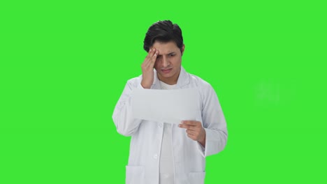 Stressed-Indian-scientist-reading-research-papers-Green-screen