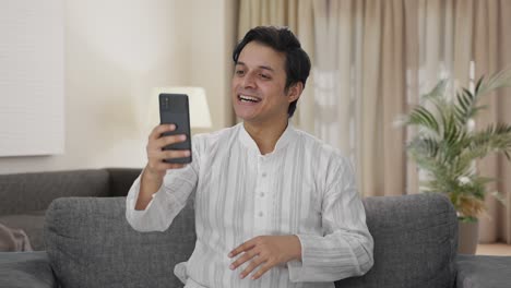 Happy-Indian-man-talking-on-video-call