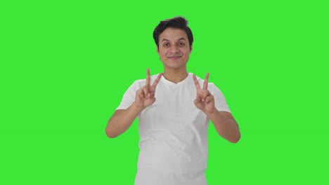 Cheerful-Indian-man-showing-victory-sign-Green-screen
