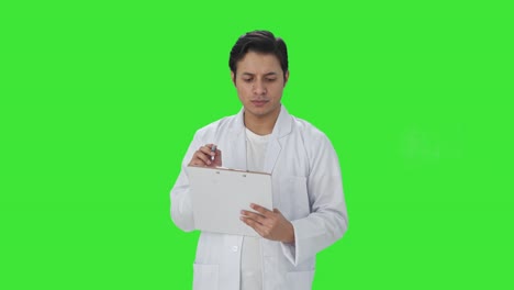 Cheerful-Indian-scientist-writing-observations-Green-screen