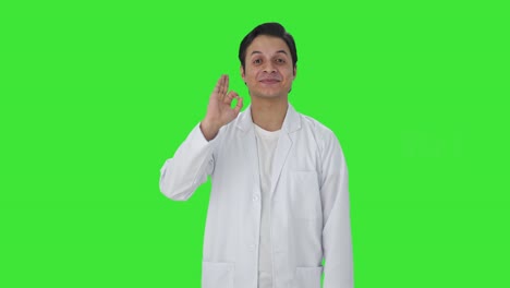 Happy-Indian-scientist-showing-okay-sign-Green-screen