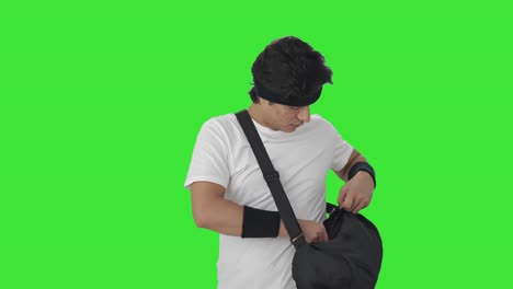 Indian-man-taking-out-towel-from-duffel-bag-and-wiping-sweat-Green-screen